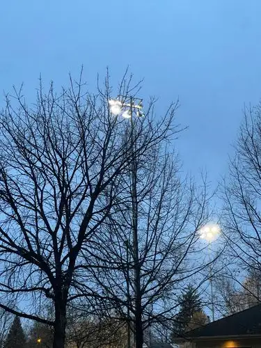 The silent glow of stadium lights at twilight.